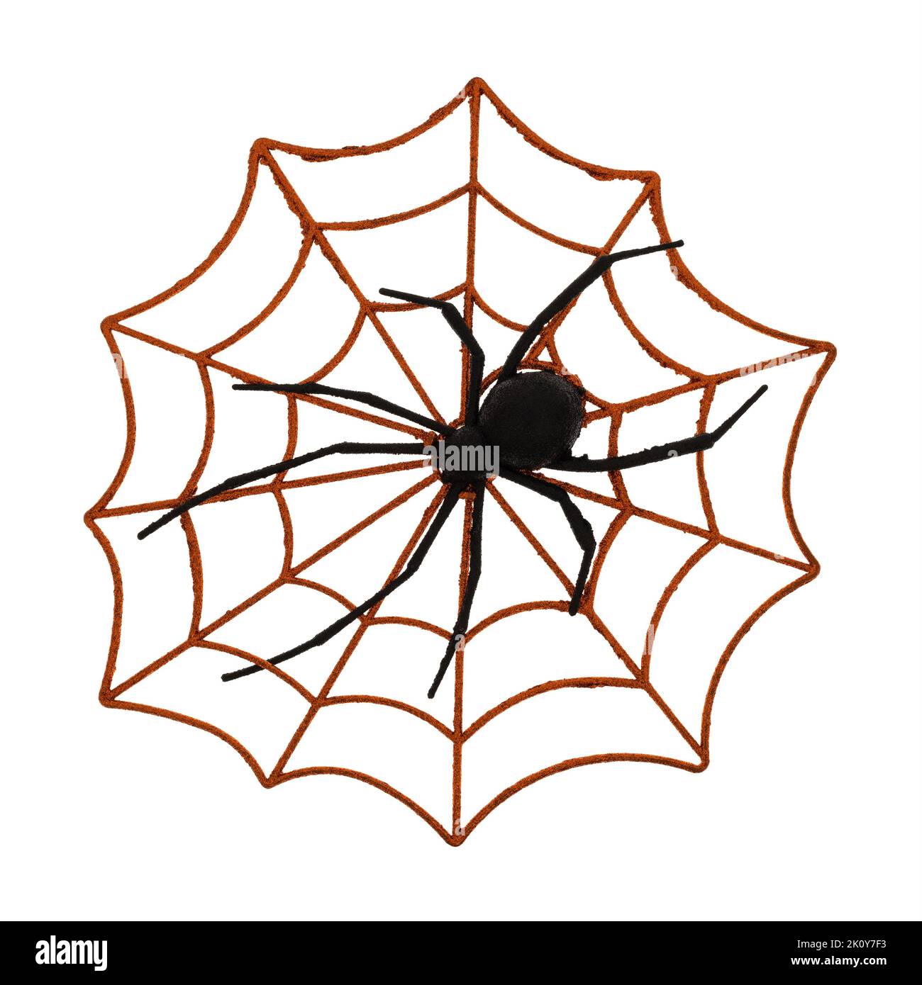 Orange Halloween spider web with plastic spider on a white background. Stock Photo