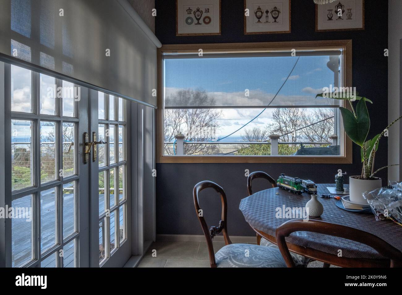 A pleasant interior with chairs, multipanel glazed doors and roller