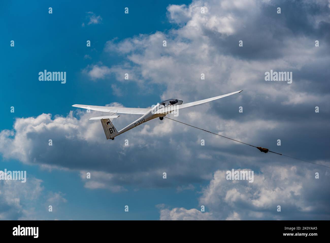 Hamburg, Germany - 08 21 2022:a glider still attached to the tow cable in the sky after take-off Stock Photo