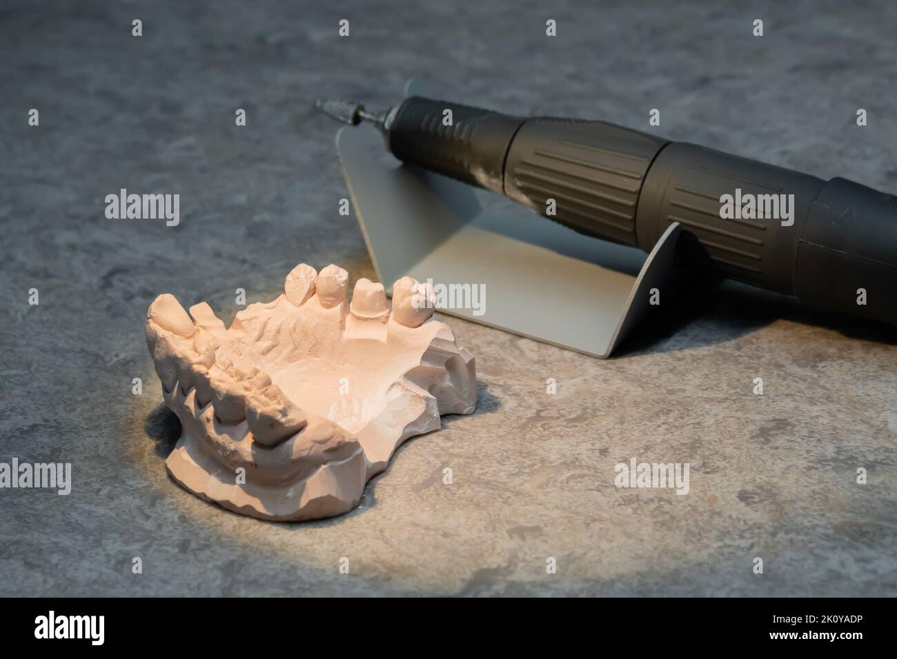 Dental gypsum jaw and motor handpiece tool model for training Stock Photo Alamy
