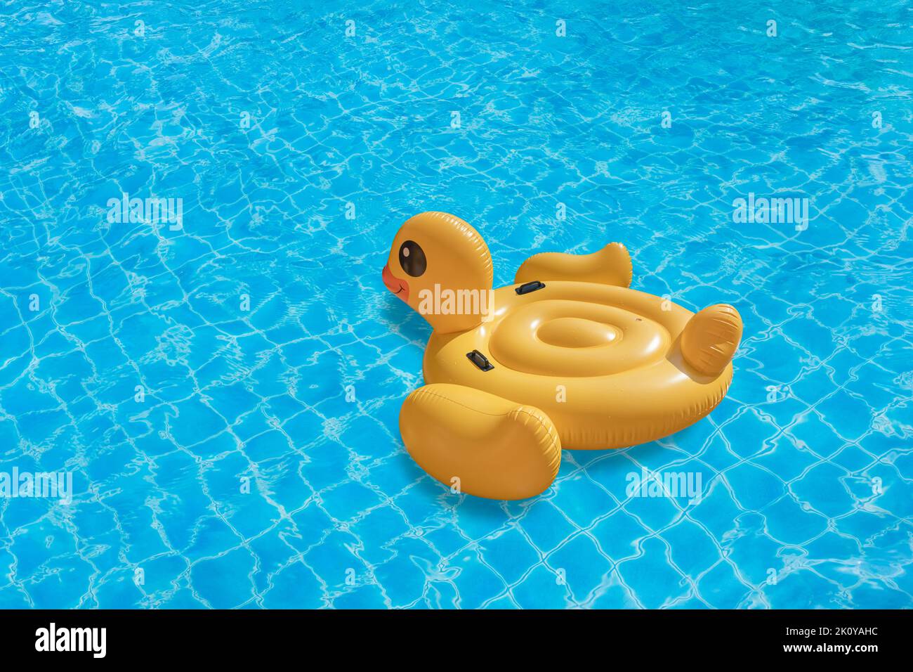 Duck shaped inflatable ring on swinming pool. Concept for summer day Stock Photo