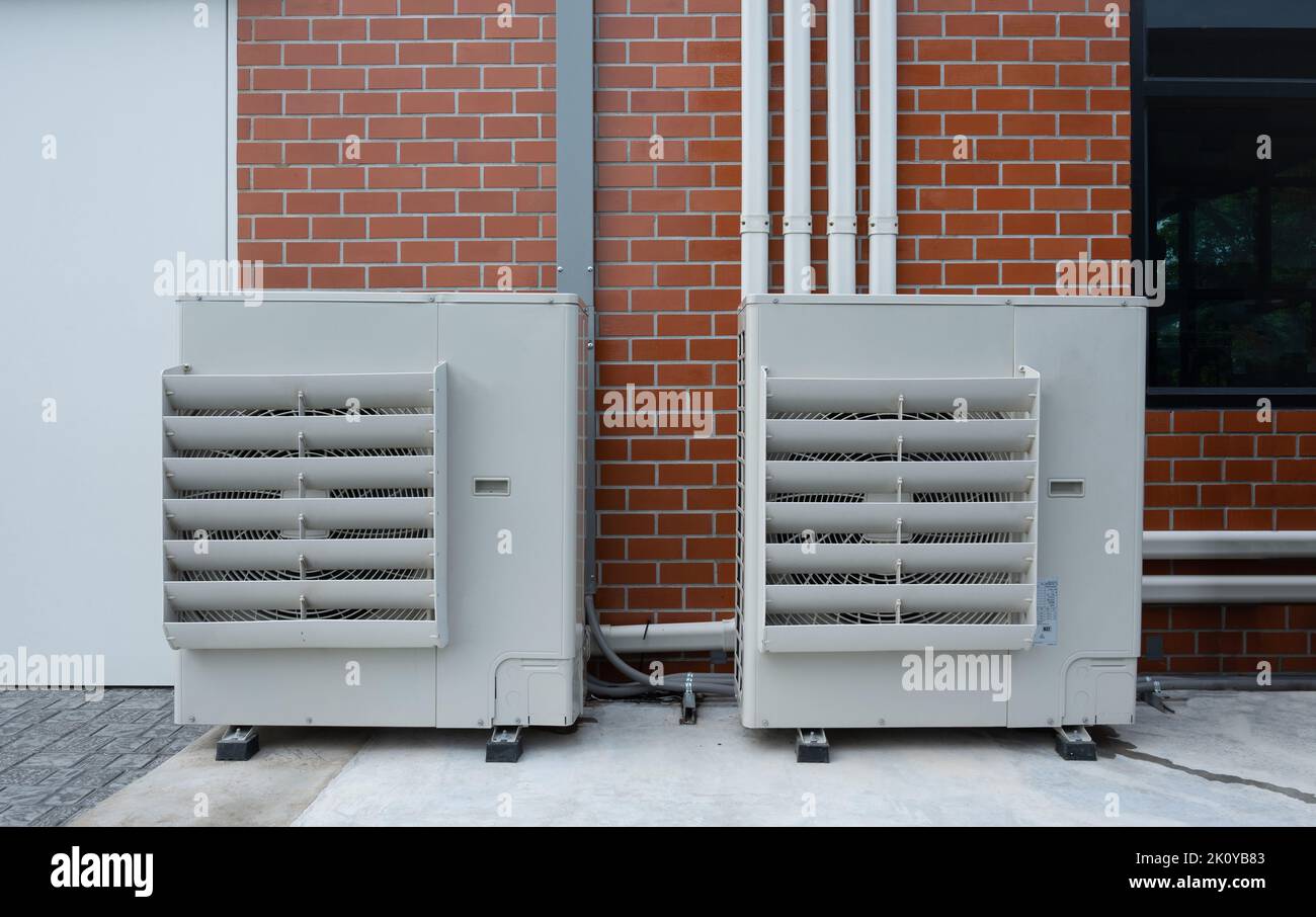 Air compressor or condenser unit installed outside building. Outdoor