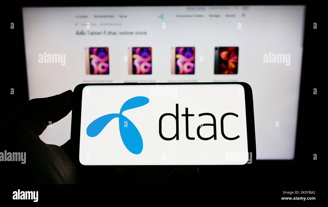Person holding phone with logo of Total Access Communication Public ...