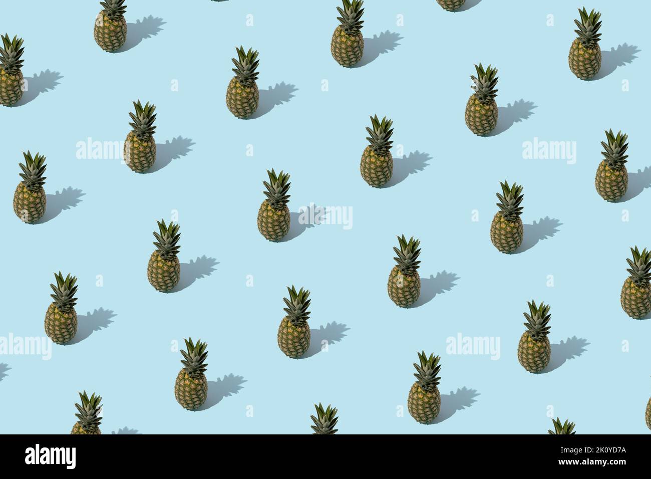 Summer pattern - pineapples on blue background. Minimal concept. Stock Photo