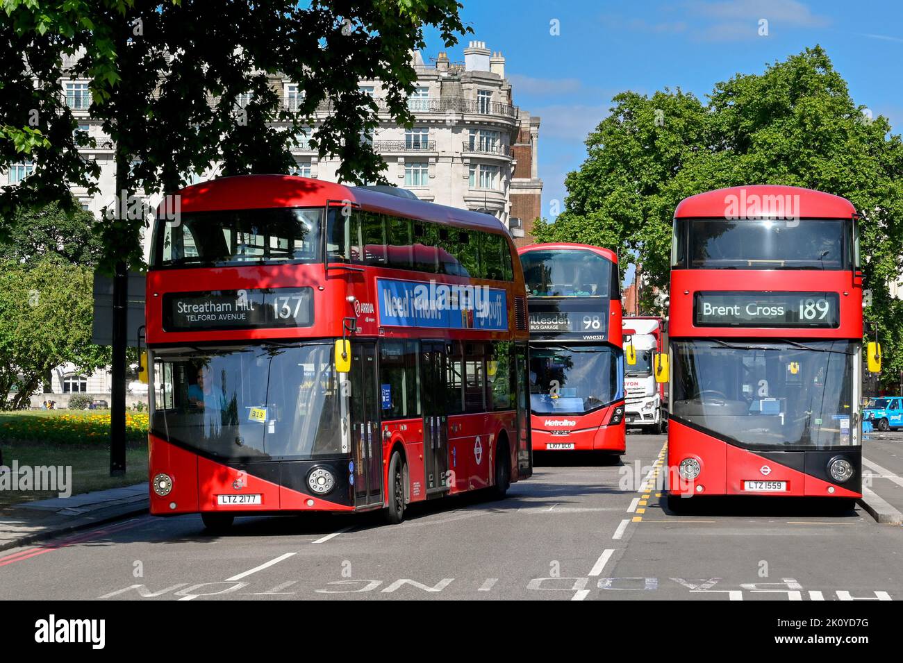 London, United Kingdom - June 2022: Red London double decker buses driving on a street in central London Stock Photo
