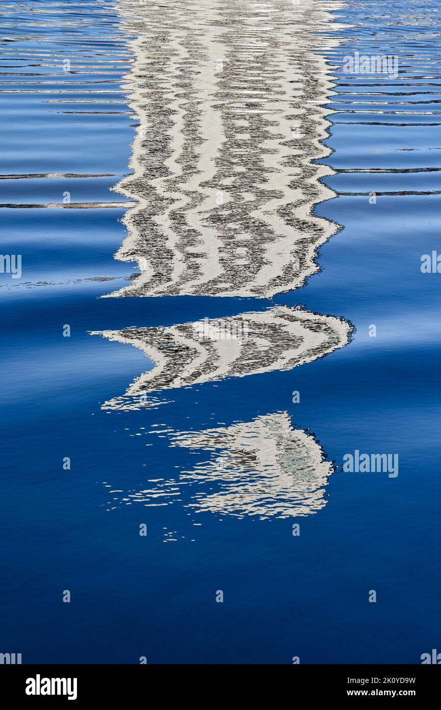 Pattern formed by the reflection of a skyscraper on rippled water. No people. Stock Photo