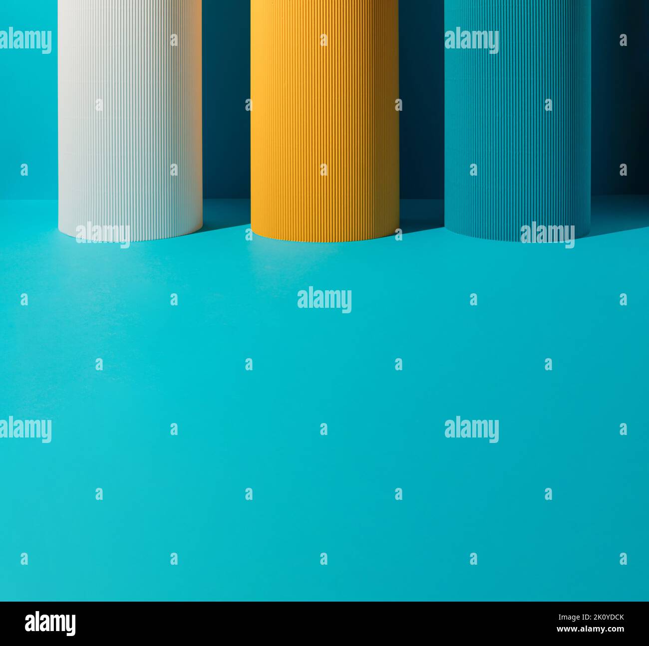 Three paper pillars white, yellow and blue on blue background with copy space Stock Photo Alamy