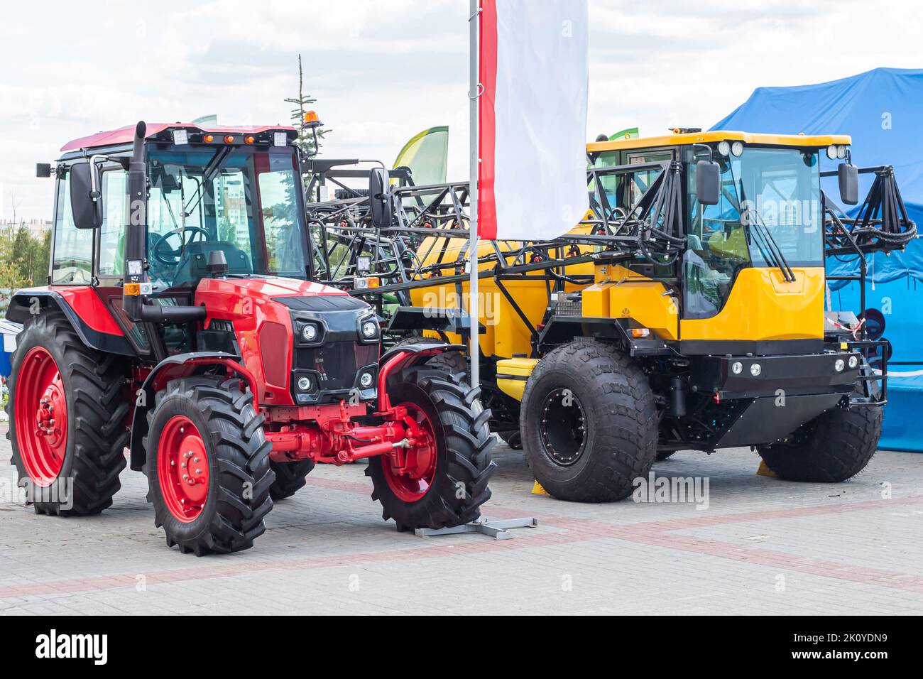 Trackter Vehicles Red wheeled tractor and yellow agricultural all-terrain vehicle with ...