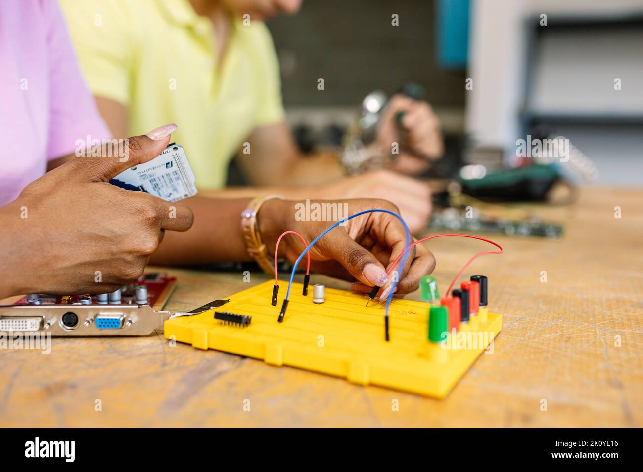 Close up female student hands creating electronic circuits and robotics at class Stock Photo