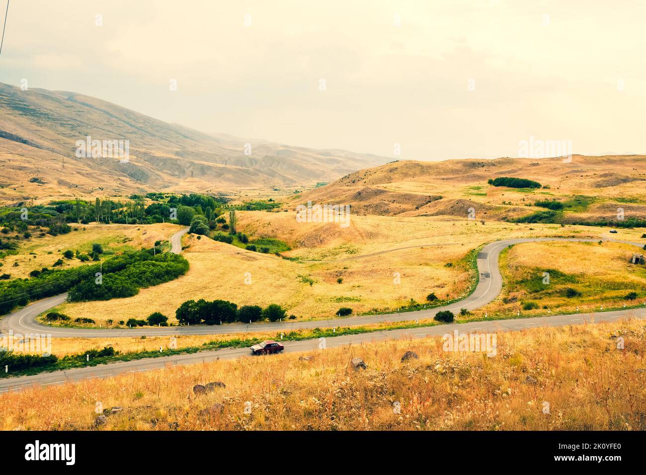 Automobile drive in countryside serpentine road outdoors in nature with