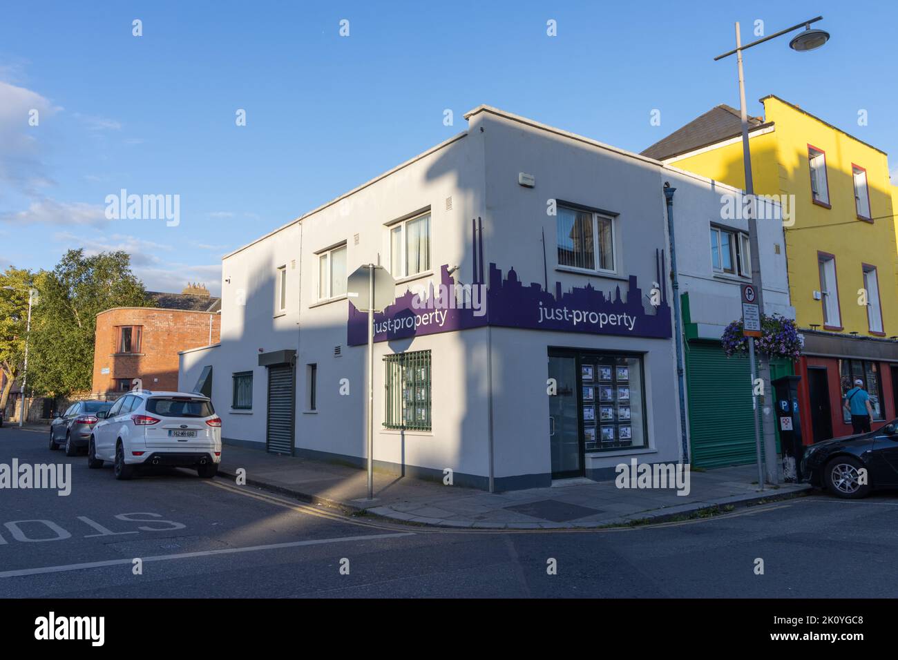 The building of the Property Renting Agency in pastel colors at the street corner in Dublin. Stock Photo