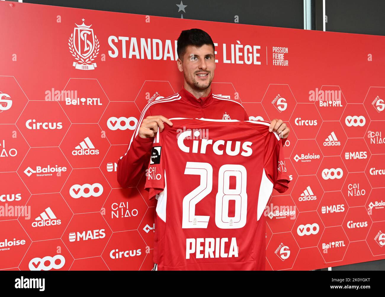 Standard's Stipe Perica poses with his jersey at a press conference of