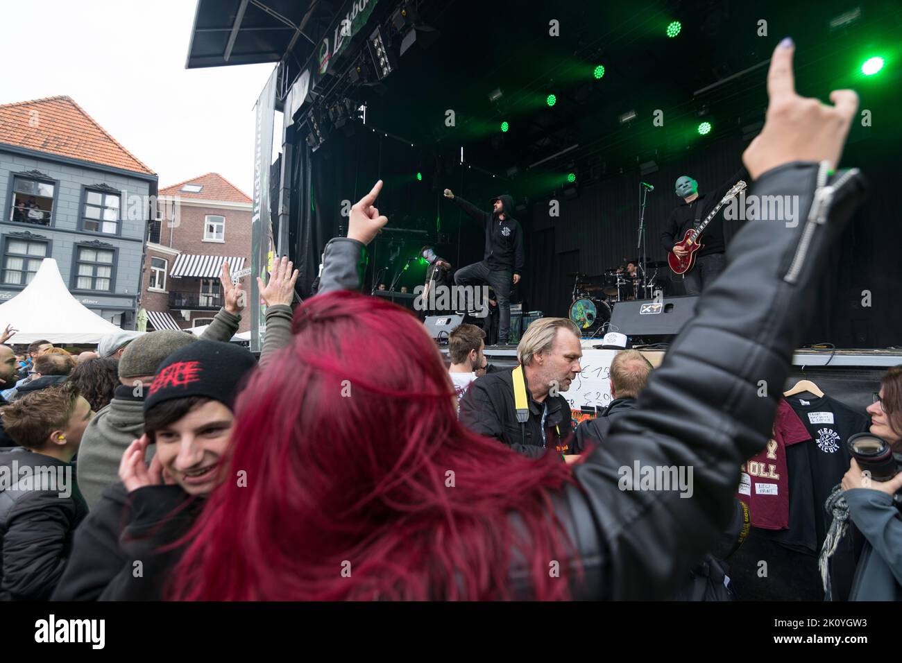 Young people dancing in front of the stage at live performance of a rock band, Netherlands Stock Photo