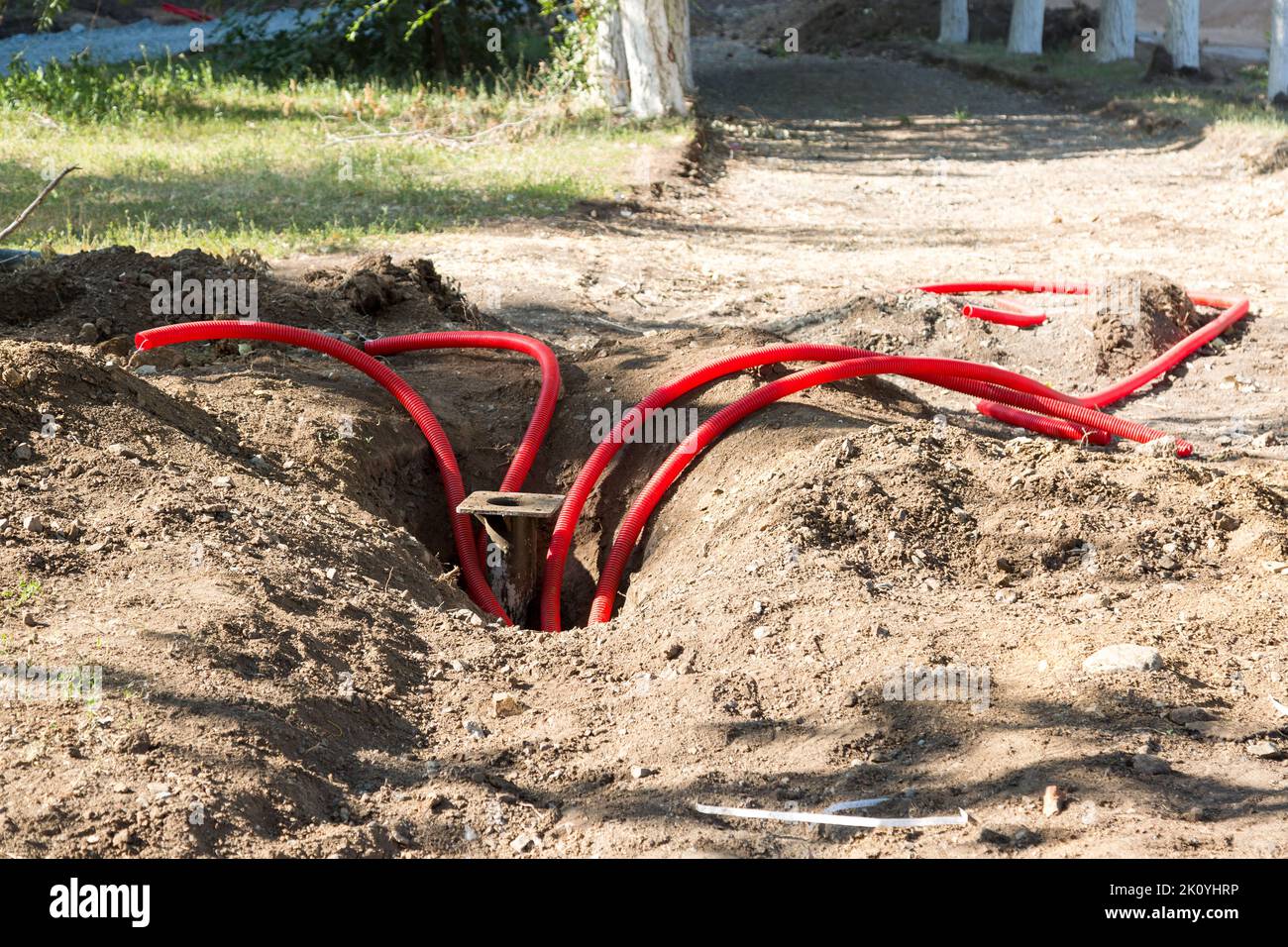 Red plastic pipes lowered deep into the pit for irrigation and irrigation earth Stock Photo Alamy
