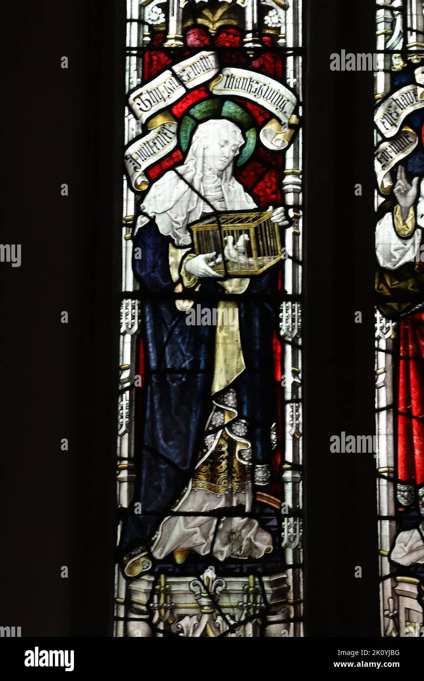 Stained glass window by Percy Bacon & Brothers depicting the Virgin Mary at the presentation in the Temple, Church of St Ladoca, Ladock, Cornwall Stock Photo