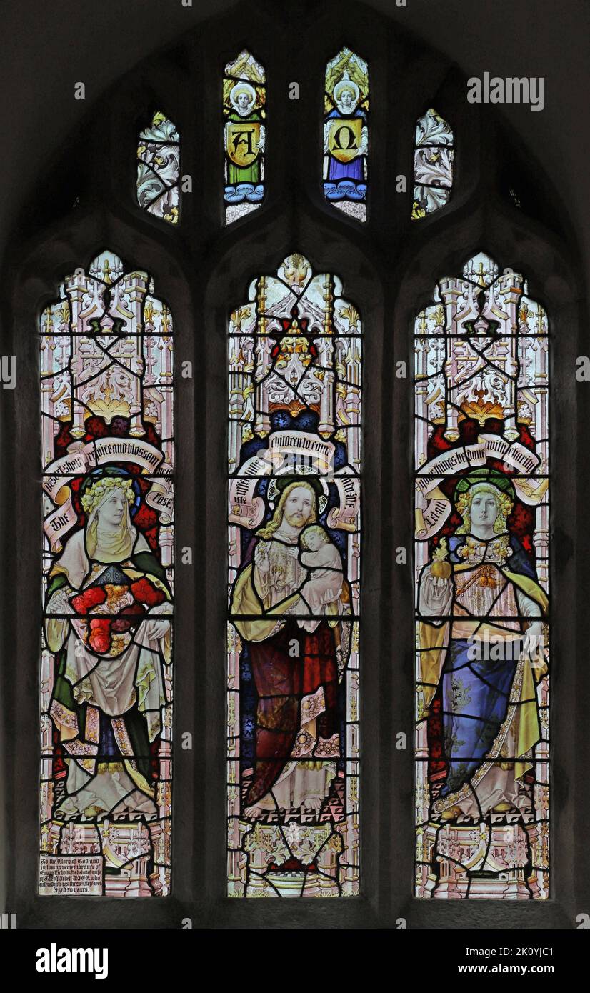 Stained glass window by Percy Bacon & Brothers depicting Jesus flanked by Faith & Charity, Church of St Ladoca, Ladock, Cornwall Stock Photo