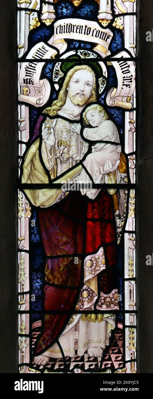 Stained glass window by Percy Bacon & Brothers depicting Jesus holding a child, Church of St Ladoca, Ladock, Cornwall Stock Photo
