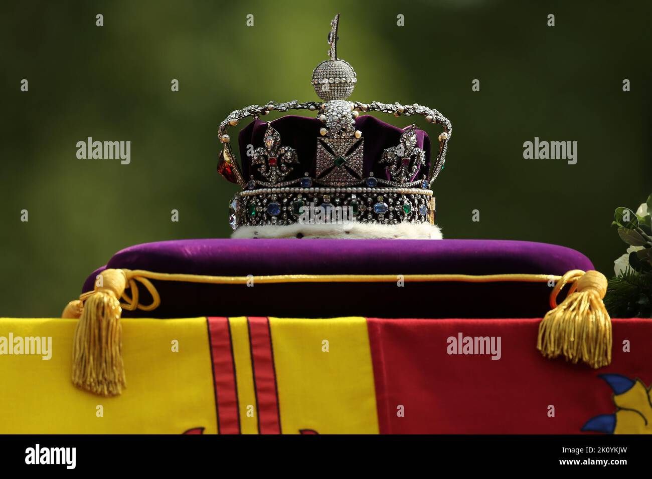 The coffin of Queen Elizabeth II, draped in the Royal Standard with the Imperial State Crown placed on top, is carried on a horse-drawn gun carriage of the King's Troop Royal Horse Artillery, during the ceremonial procession from Buckingham Palace to Westminster Hall, London, where it will lie in state ahead of her funeral on Monday. Picture date: Wednesday September 14, 2022. Stock Photo