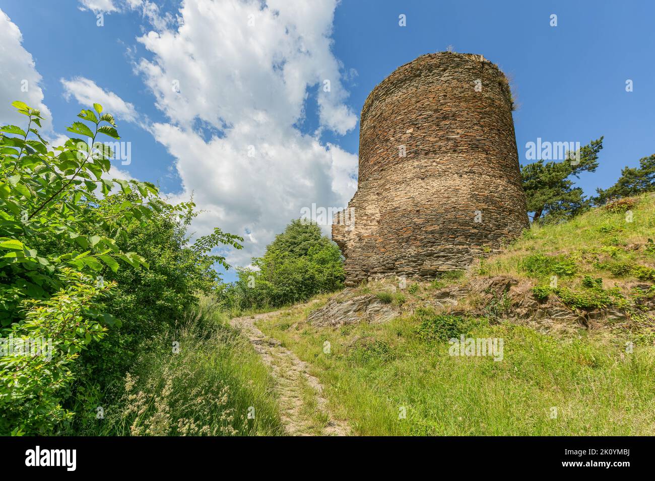 Rabstejn nad Strelou, Czech Republic - June 12 2022: View of the stone tower, a part of the former Sychrov castle, standing on a steep hill. Green gra Stock Photo