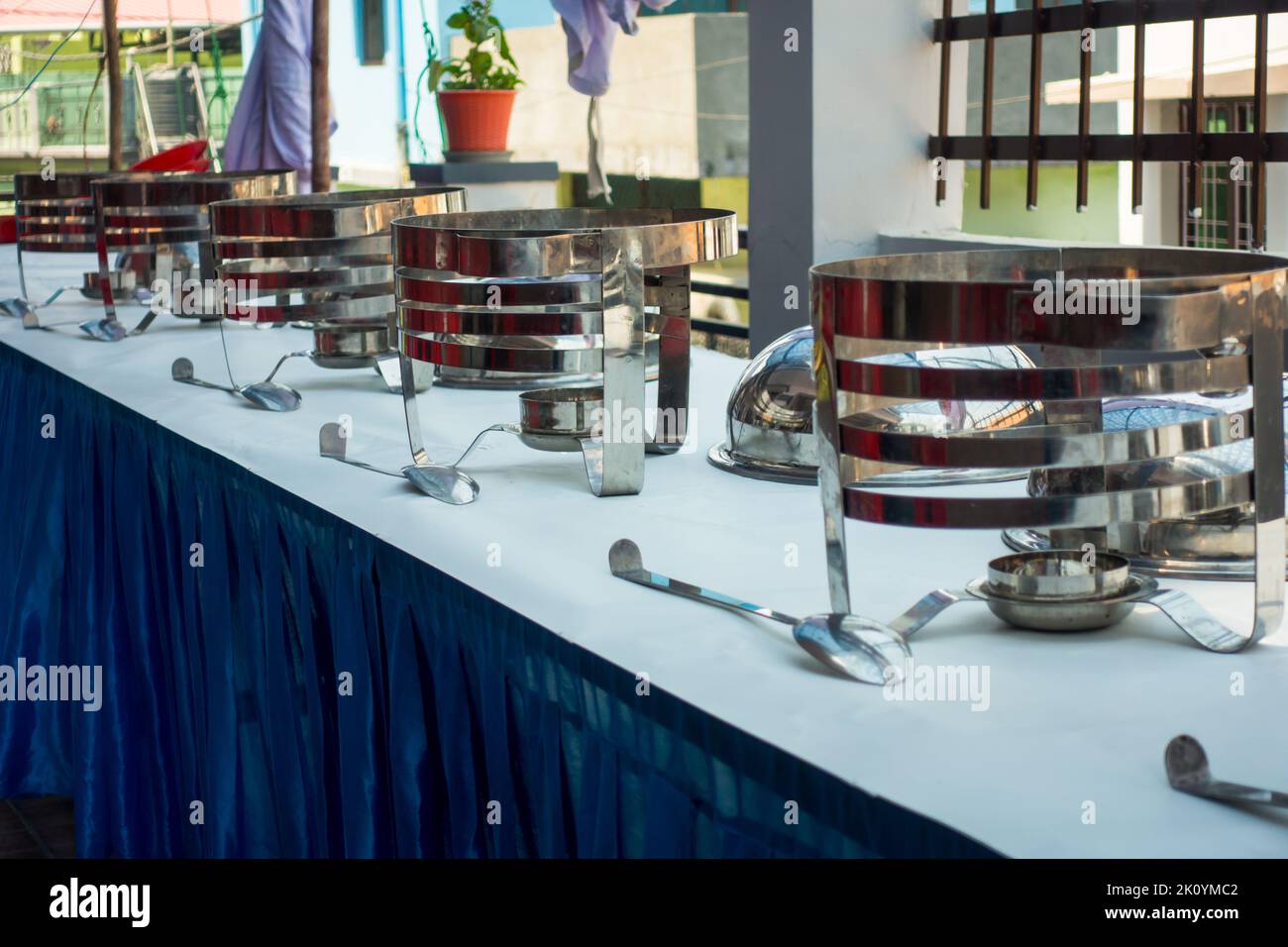 April 13th 2022, Dehradun City Uttarakhand India. Preparation of Buffet with large, stainless steel containers with a sterno fuel source before meals. Stock Photo
