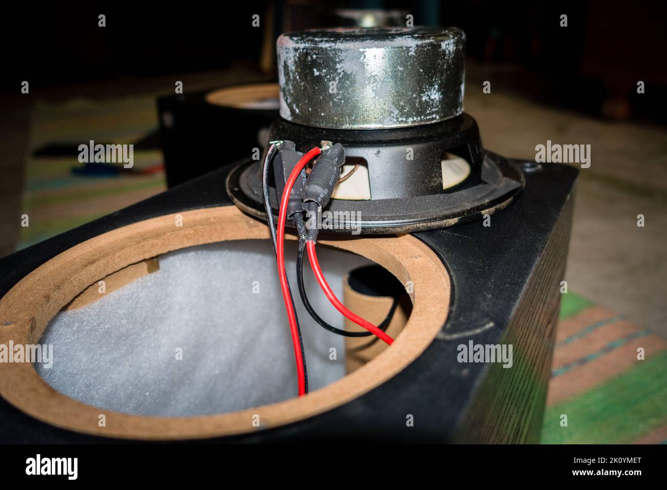 April 13th 2022, Dehradun City Uttarakhand India. A dismantled speaker with exposed wiring and sub woofer unit driver with a large magnet. Stock Photo