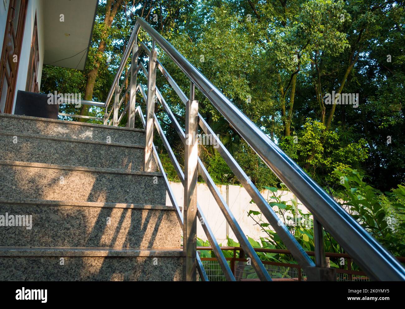 A closeup shot of granite stone staircase with steel railings in a ...