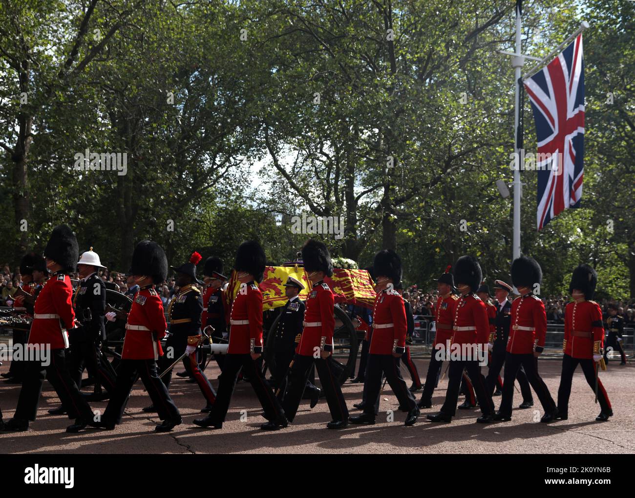 The coffin of Queen Elizabeth II, draped in the Royal Standard with the Imperial State Crown placed on top, is carried on a horse-drawn gun carriage of the King's Troop Royal Horse Artillery, during the ceremonial procession from Buckingham Palace to Westminster Hall, London, where it will lie in state ahead of her funeral on Monday. Picture date: Wednesday September 14, 2022. Stock Photo