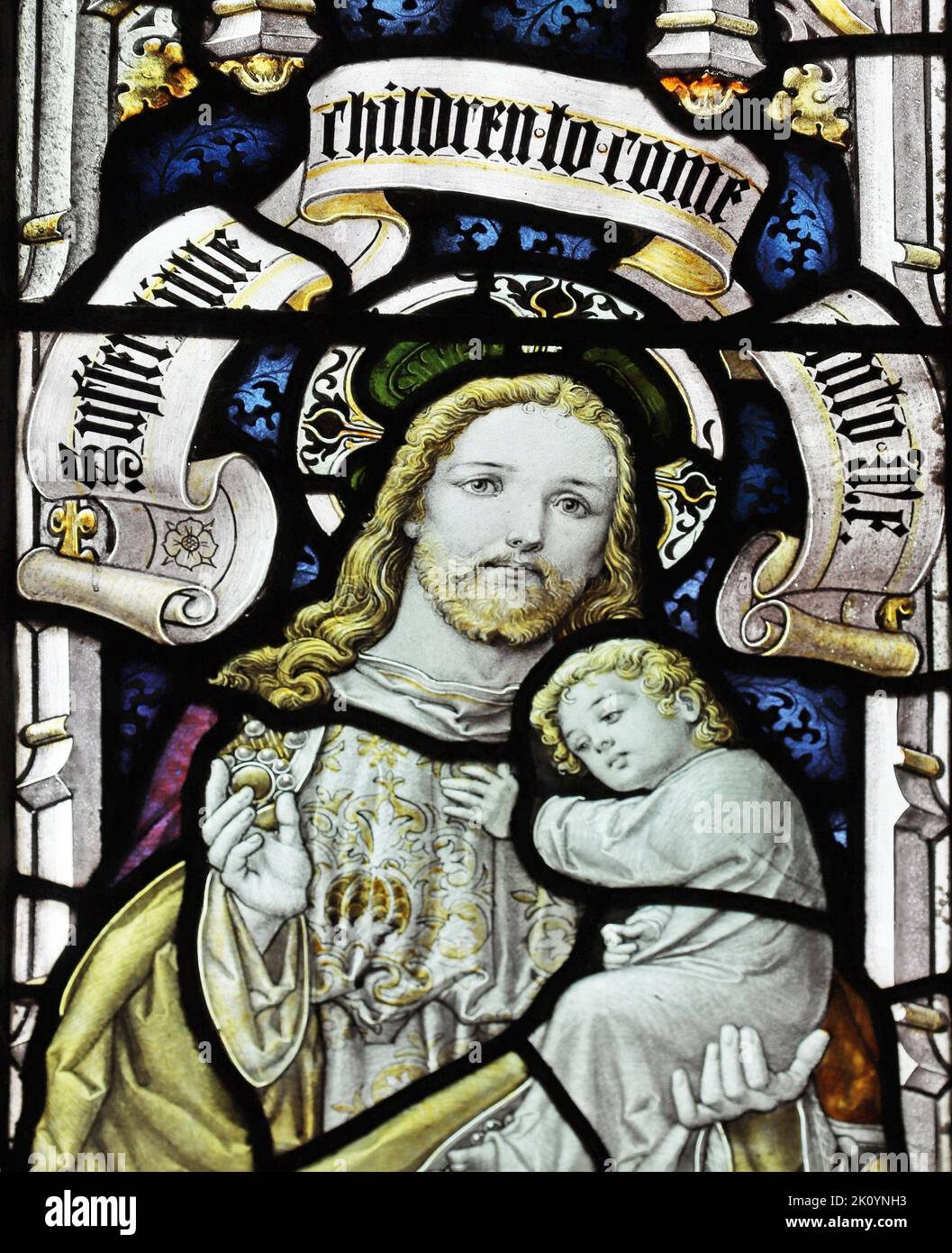 Stained glass window by Percy Bacon & Brothers depicting Christ holding a child, Church of St Ladoca, Ladock, Cornwall Stock Photo