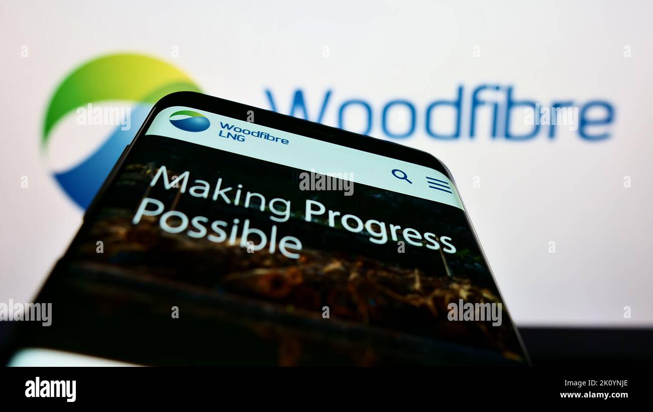 Mobile phone with website of Canadian gas company Woodfibre LNG Limited on screen in front of business logo. Focus on top-left of phone display. Stock Photo
