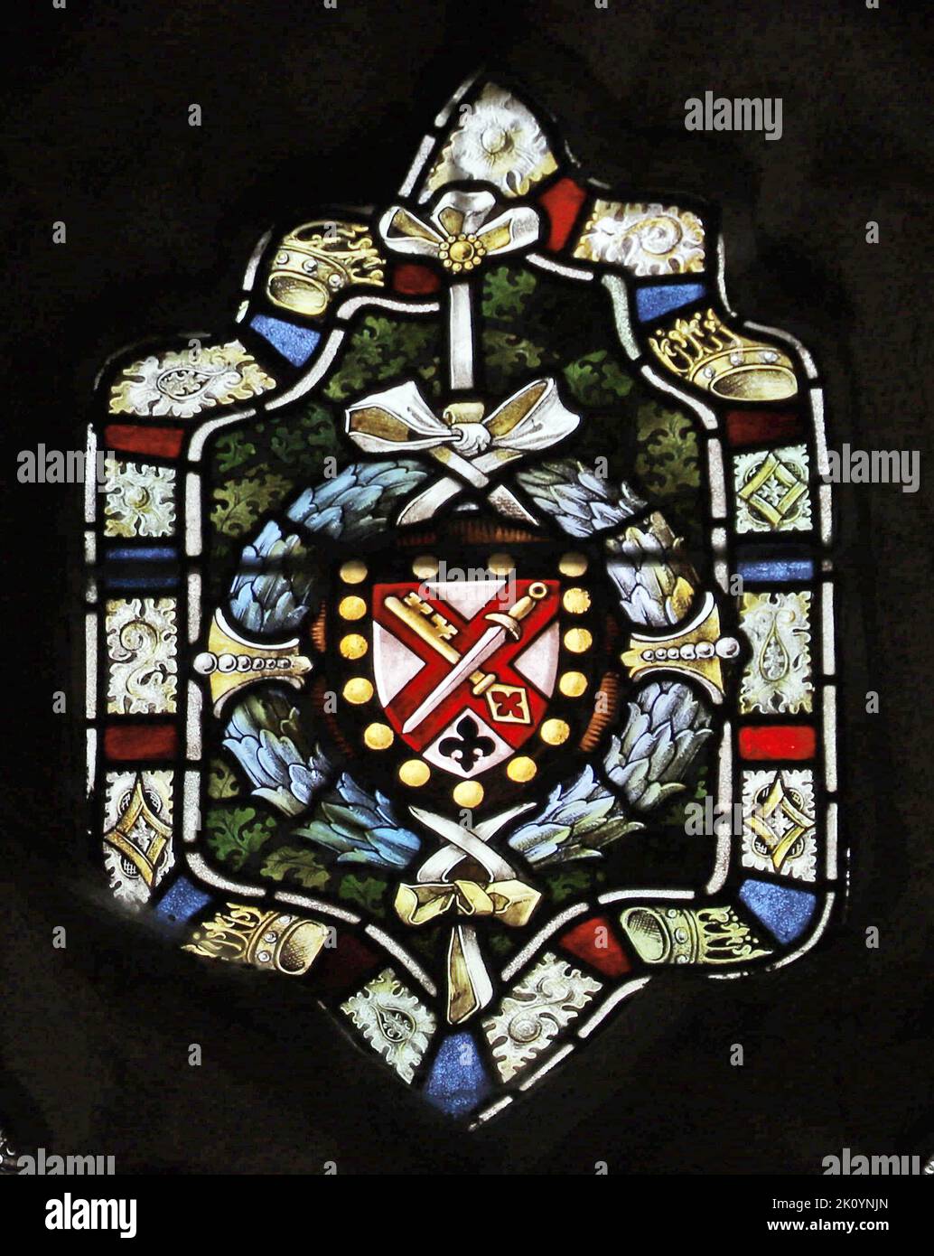Stained glass window by Percy Bacon & Brothers depicting arms of the diocese of Truro, St James Church St Kew, Cornwall Stock Photo