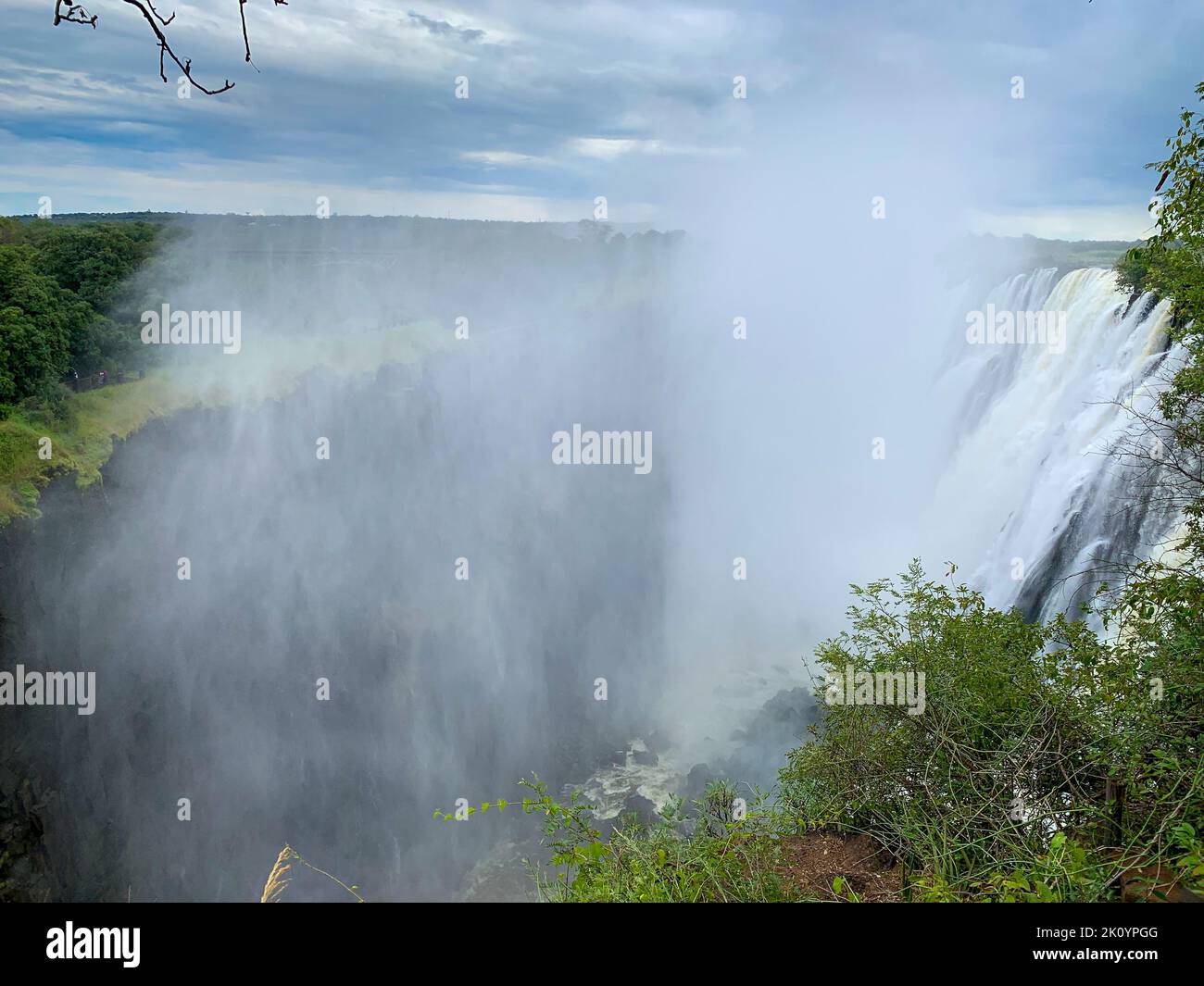 Enormous mist rises from the cascading waters of Victoria Falls. Stock Photo