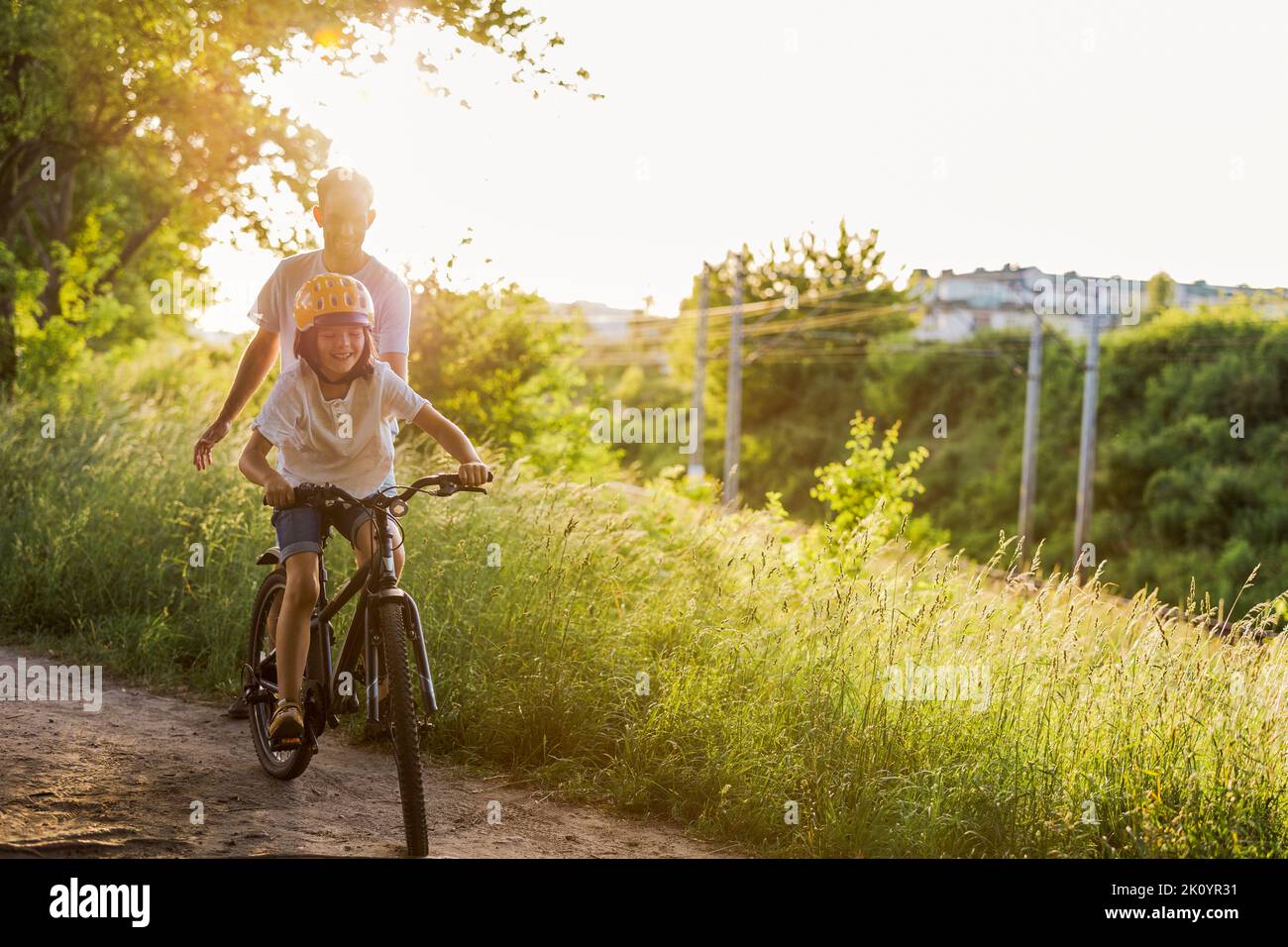 Father teaching his son how to ride a bicycle Stock Photo