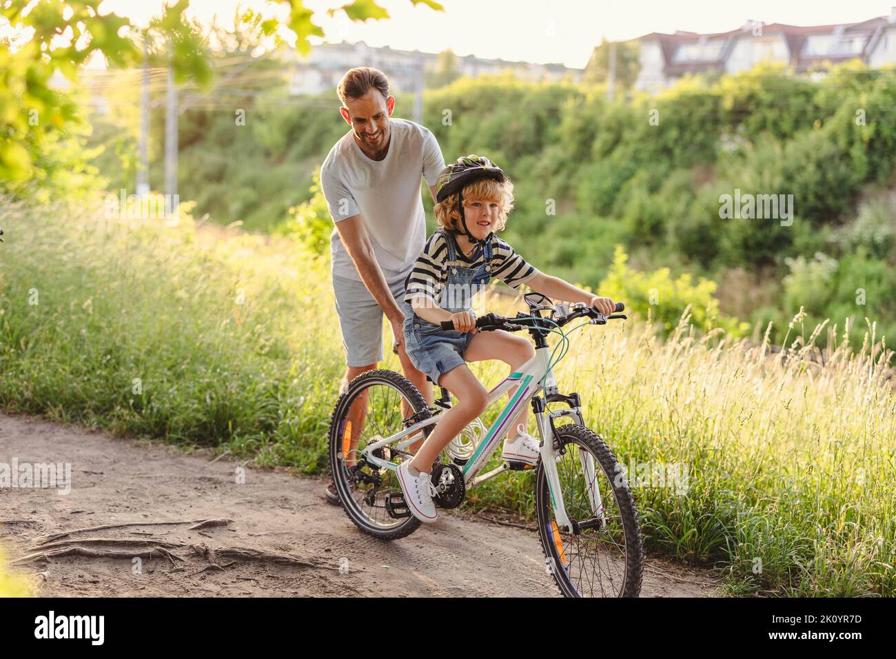 Father teaching his son how to ride a bicycle Stock Photo