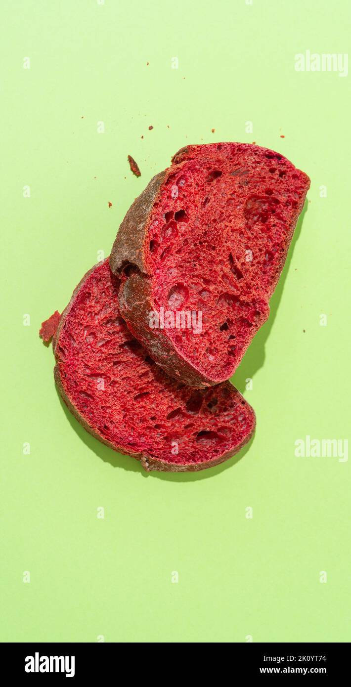 Beetroot purple bun slices on green background. Stock Photo