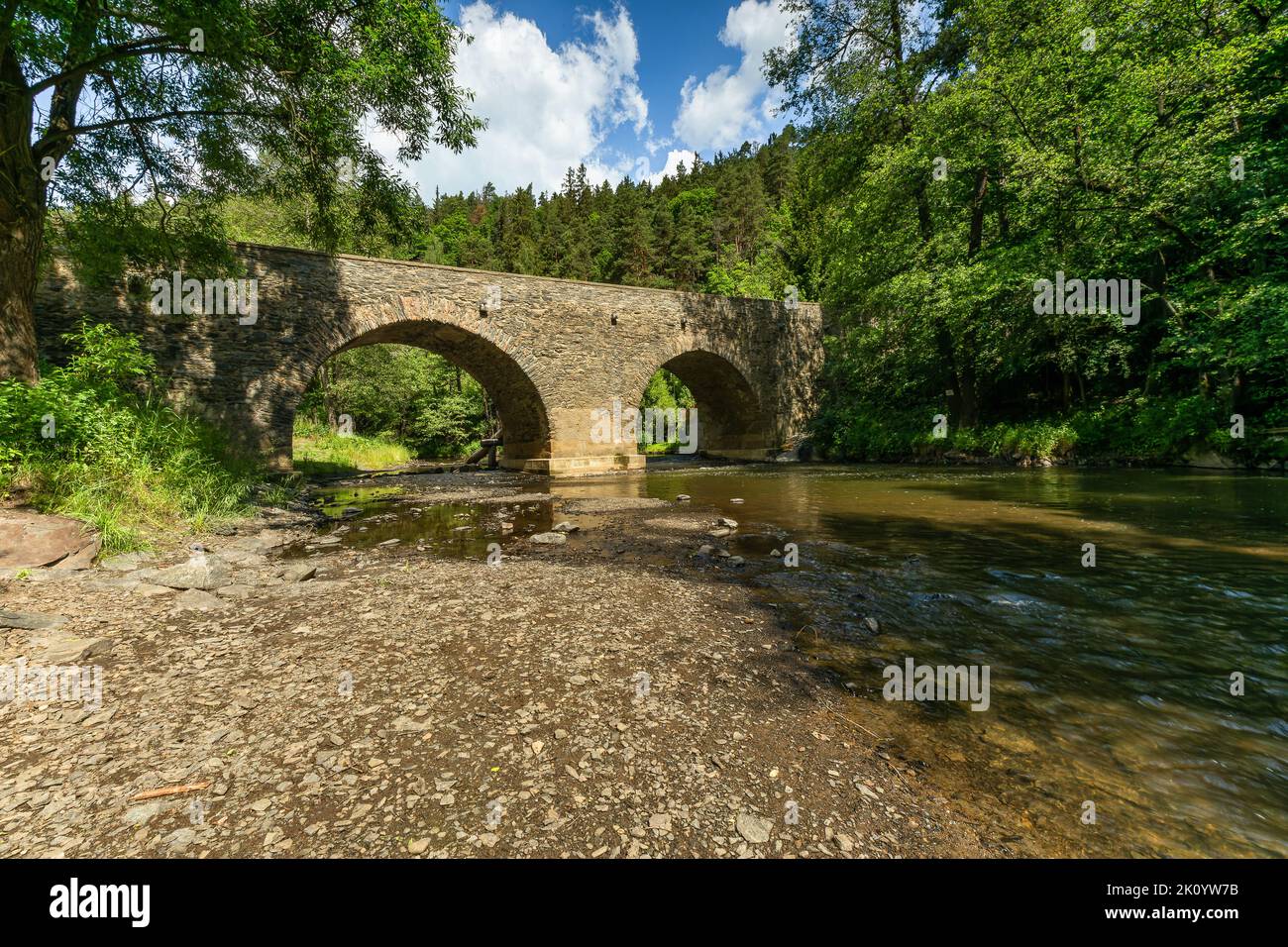 Rabstejn nad Strelou, Czech Republic - June 12 2022: View of the historical sandstone bridge over the river Strela made in the 14th century, a second Stock Photo