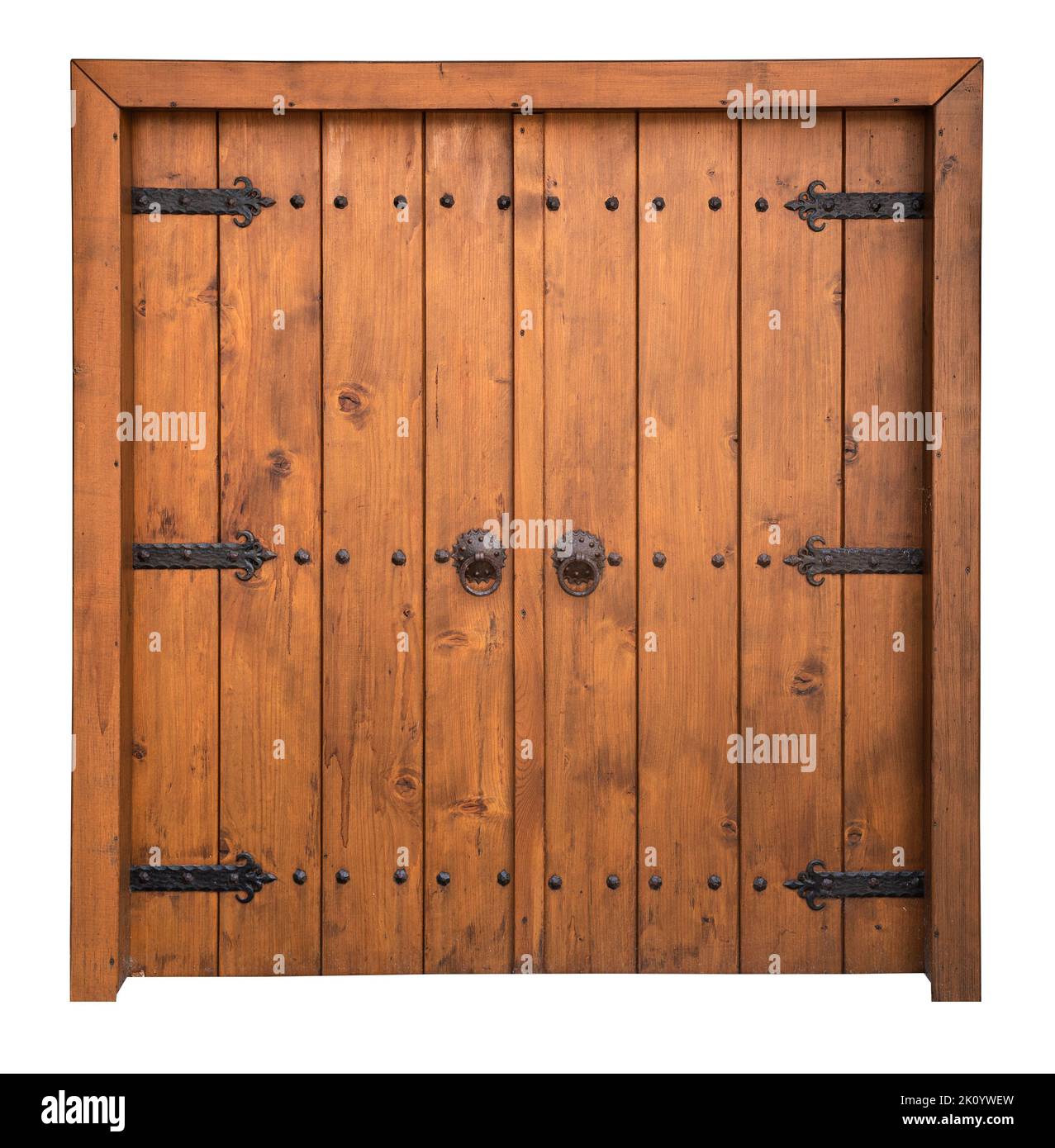 front view closeup of vintage wooden large double barn door with brown wood texture and metallic handle and bolts isolated on white background Stock Photo