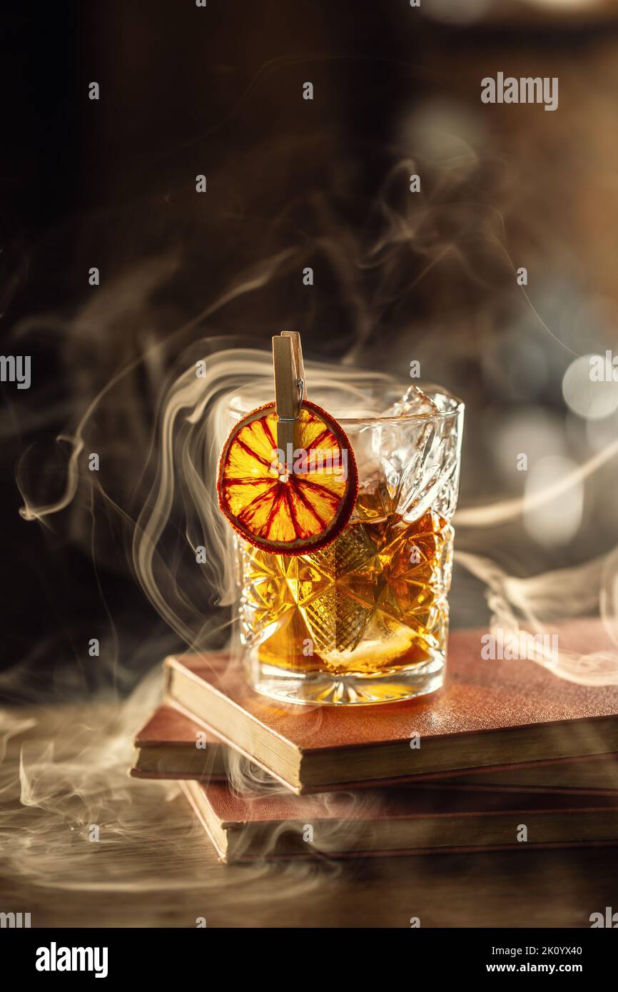 Glass cup with Old Fashioned cocktail in retro style. Stock Photo