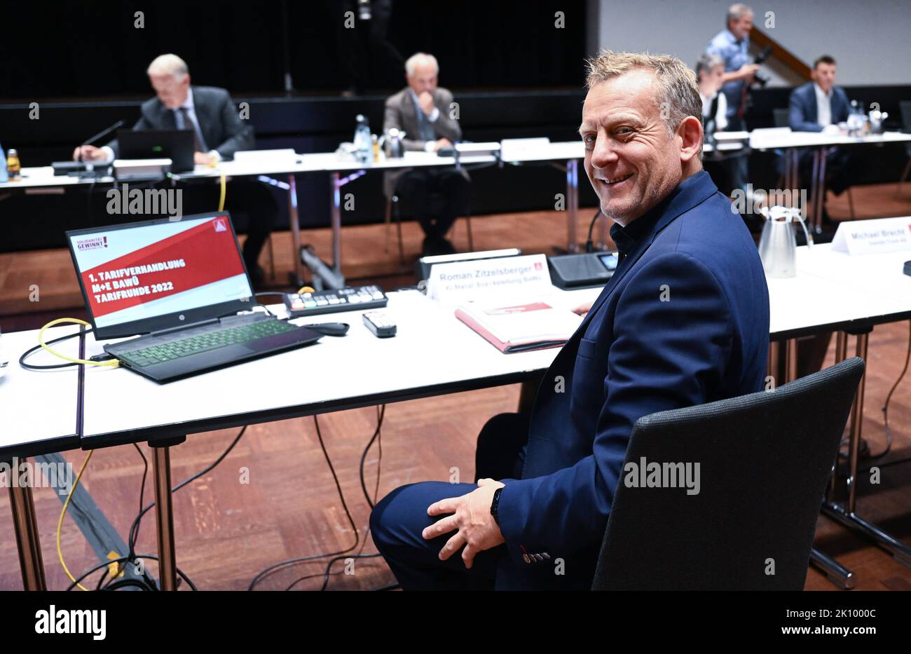 Kornwestheim, Germany. 14th Sep, 2022. Roman Zitzelsberger (r), District Manager Baden-Württemberg of the IG Metall trade union, sits opposite the negotiators from Südwestmetall at the Congress Center before the start of collective bargaining for the metal and electrical industry in the southwest. Credit: Bernd Weißbrod/dpa/Alamy Live News Stock Photo