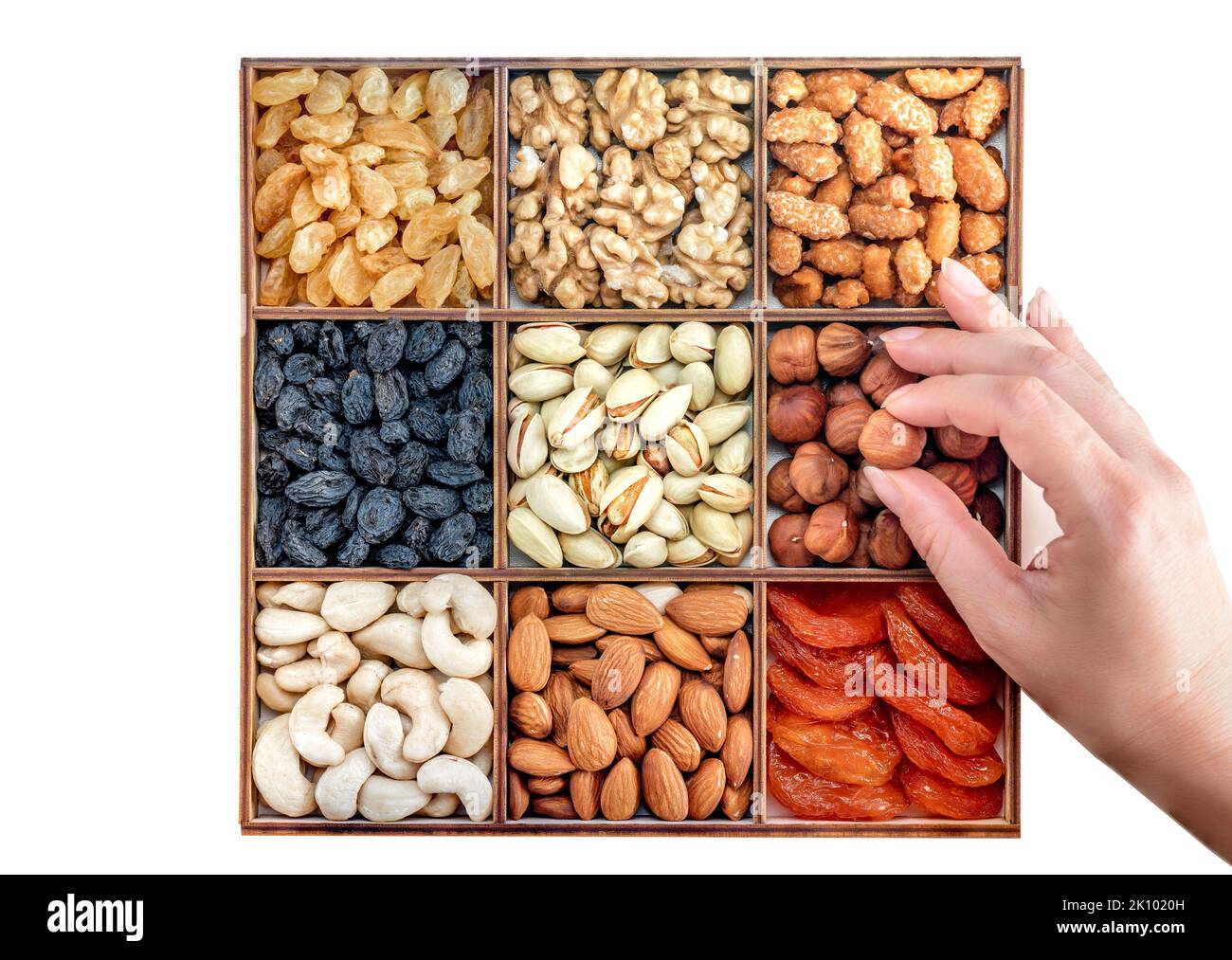 Hand with assorted nuts and dried fruit collection. Assorted nuts almonds, pistachio, cashews, walnut. Organic mixed nuts background. Healthy food, Us Stock Photo