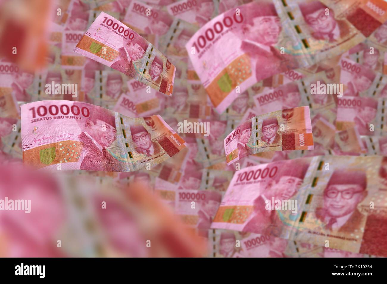 Flying 100,000 rupiah banknote isolated on rupiah background Stock Photo