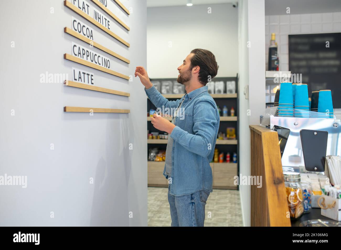A cafe owner changing menu and lookin involved Stock Photo - Alamy