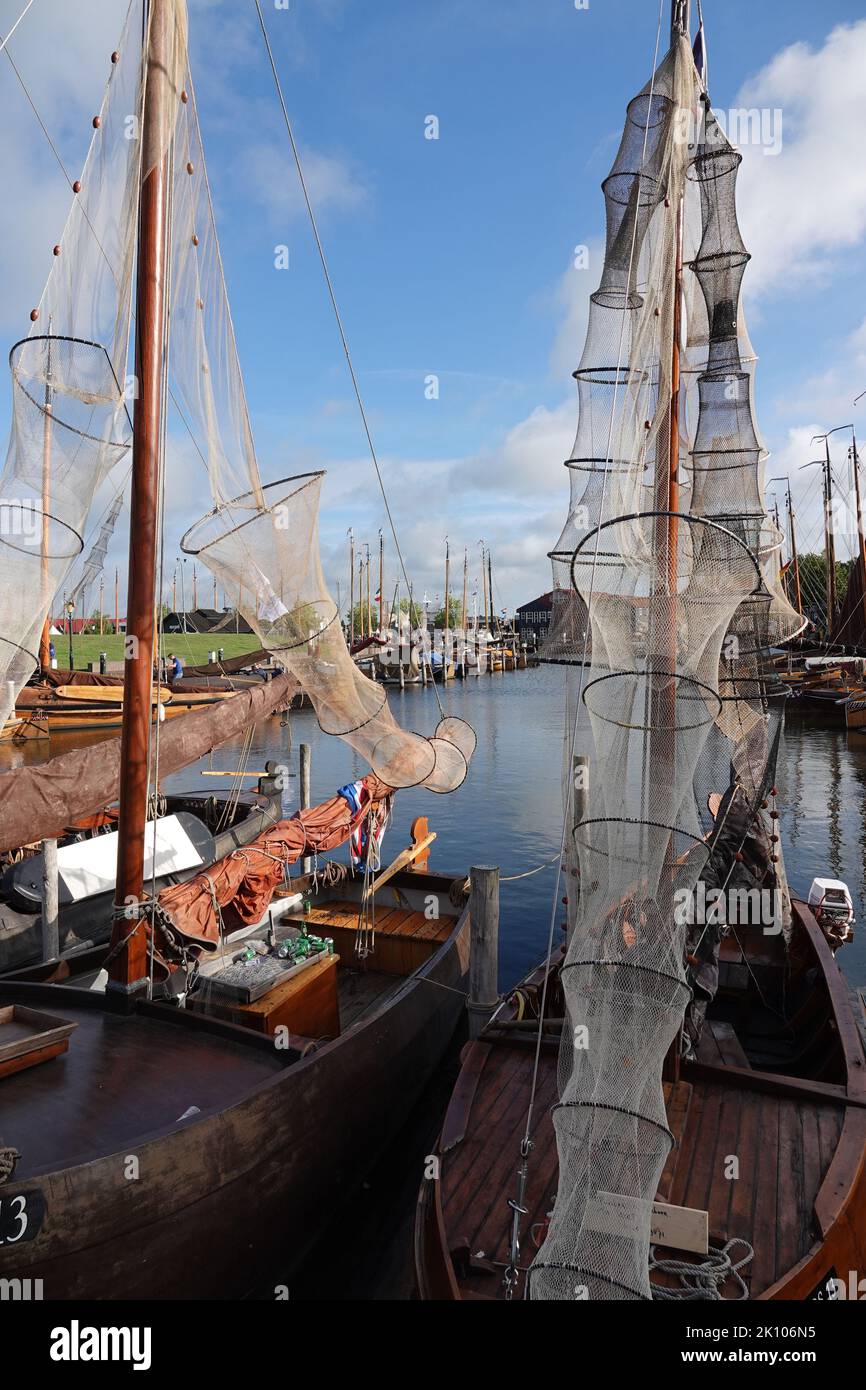Elburg, the Netherlands - Sept. 9 2022 Old boats with fishing traps (fykes) are located in the harbor of the historic fishing town of Elburg. The glor Stock Photo