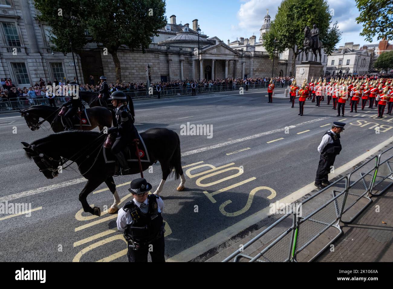 London, UK.  14 September 2022. Members of the police and Household cavalry precede the late Queen’s coffin carried on a gun carriage in Whitehall en route to Westminster Hall where it will lie in state for four days allowing the public to visit to pay their respects, ahead of the state funeral on 19 September.  Queen Elizabeth II, the longest-reigning monarch in British history, died at the age of 96 in Balmoral, Scotland and her son, now known as King Charles III, has succeeded her.  Credit: Stephen Chung / Alamy Live News Stock Photo