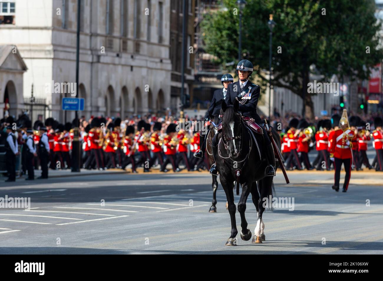 London, UK.  14 September 2022. Members of the police precede the late Queen’s coffin carried on a gun carriage in Whitehall en route to Westminster Hall where it will lie in state for four days allowing the public to visit to pay their respects, ahead of the state funeral on 19 September.  Queen Elizabeth II, the longest-reigning monarch in British history, died at the age of 96 in Balmoral, Scotland and her son, now known as King Charles III, has succeeded her.  Credit: Stephen Chung / Alamy Live News Stock Photo