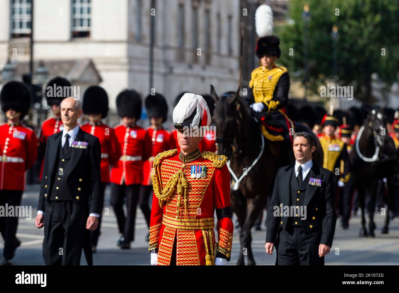 London, UK.  14 September 2022. Members of the military precede the late Queen’s coffin carried on a gun carriage in Whitehall en route to Westminster Hall where it will lie in state for four days allowing the public to visit to pay their respects, ahead of the state funeral on 19 September.  Queen Elizabeth II, the longest-reigning monarch in British history, died at the age of 96 in Balmoral, Scotland and her son, now known as King Charles III, has succeeded her.  Credit: Stephen Chung / Alamy Live News Stock Photo