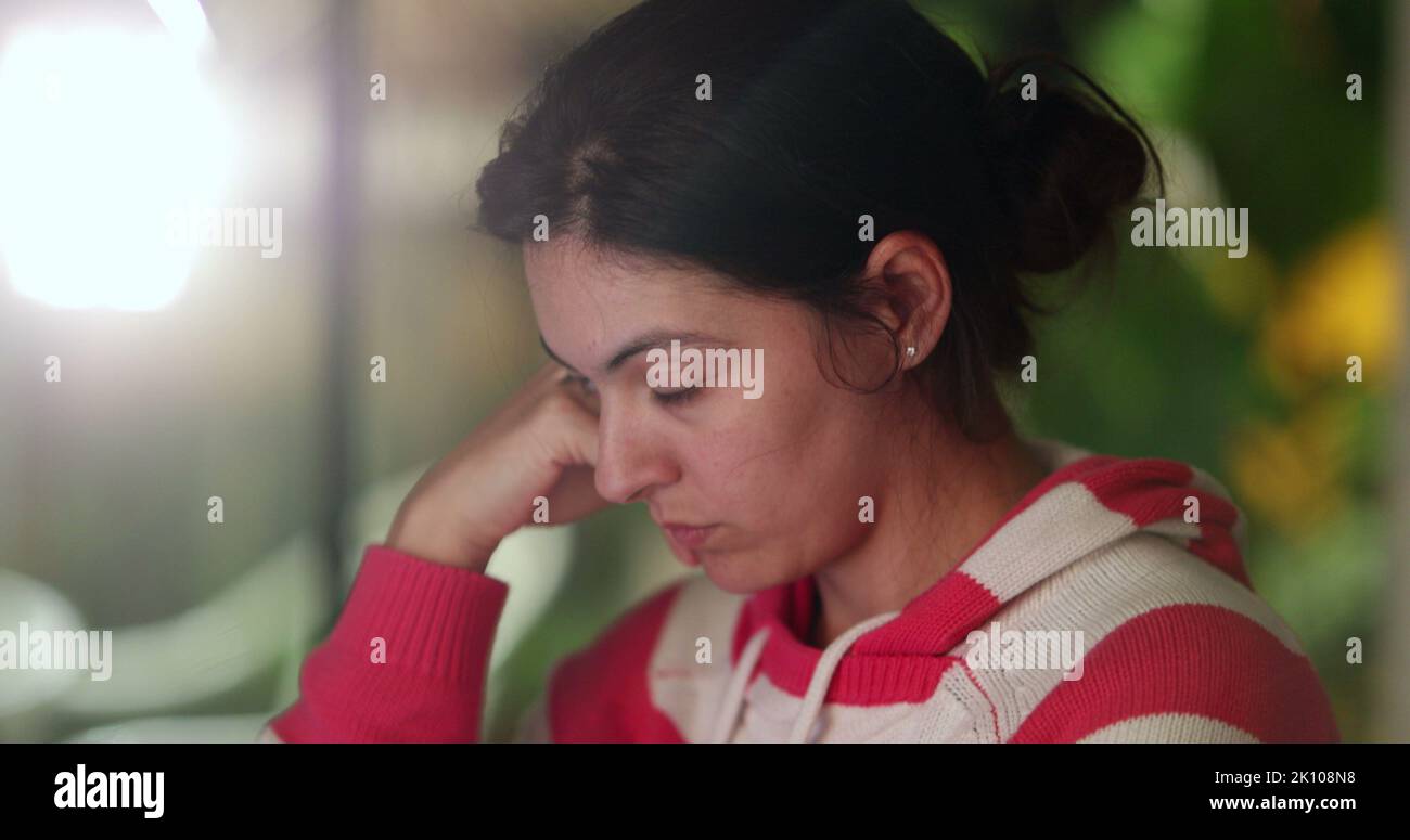 Female student doing homework late at night in front of computer taking ...