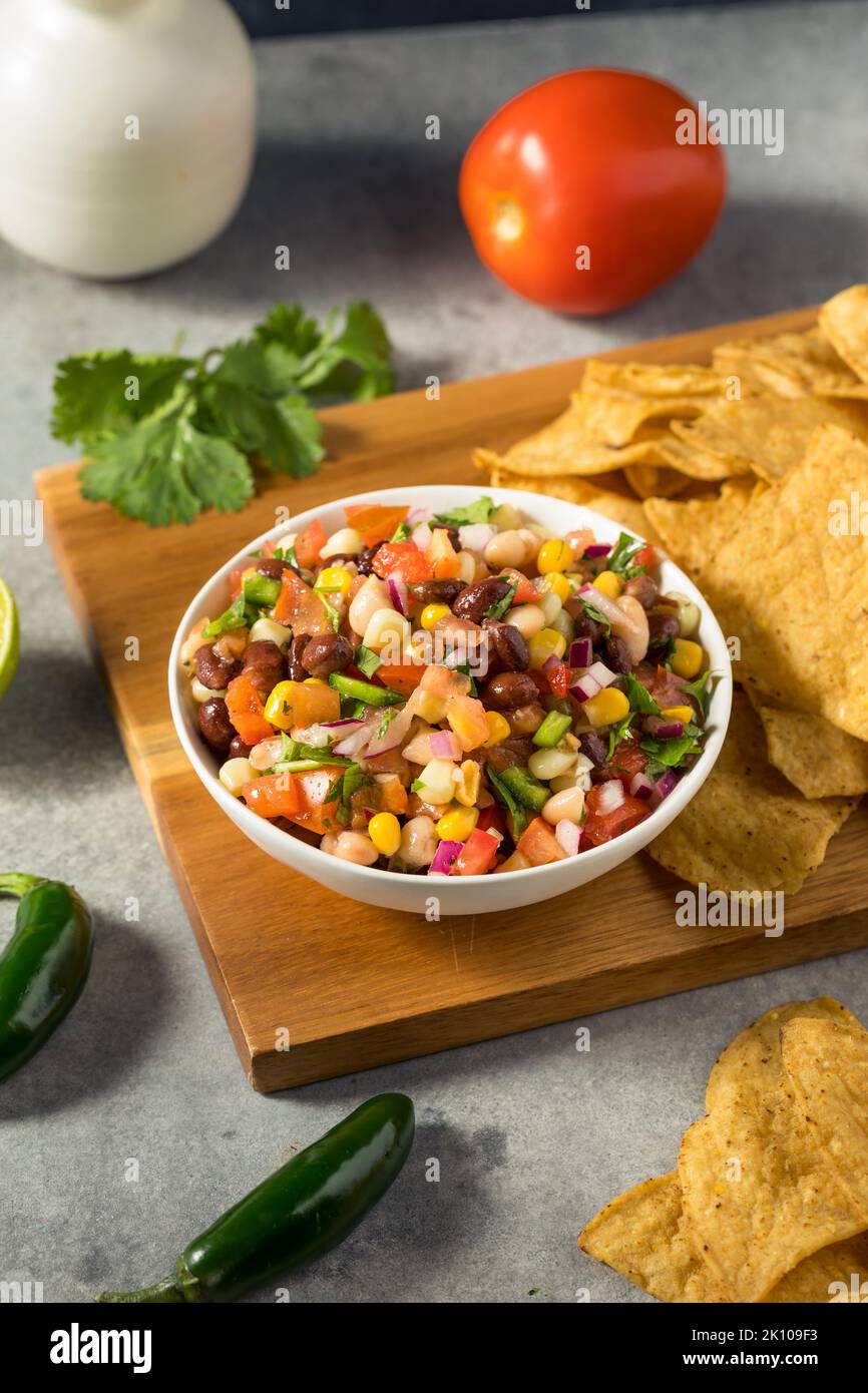 Homemade Organic Cowboy Caviar Dip with Corn Beans and Chips Stock Photo