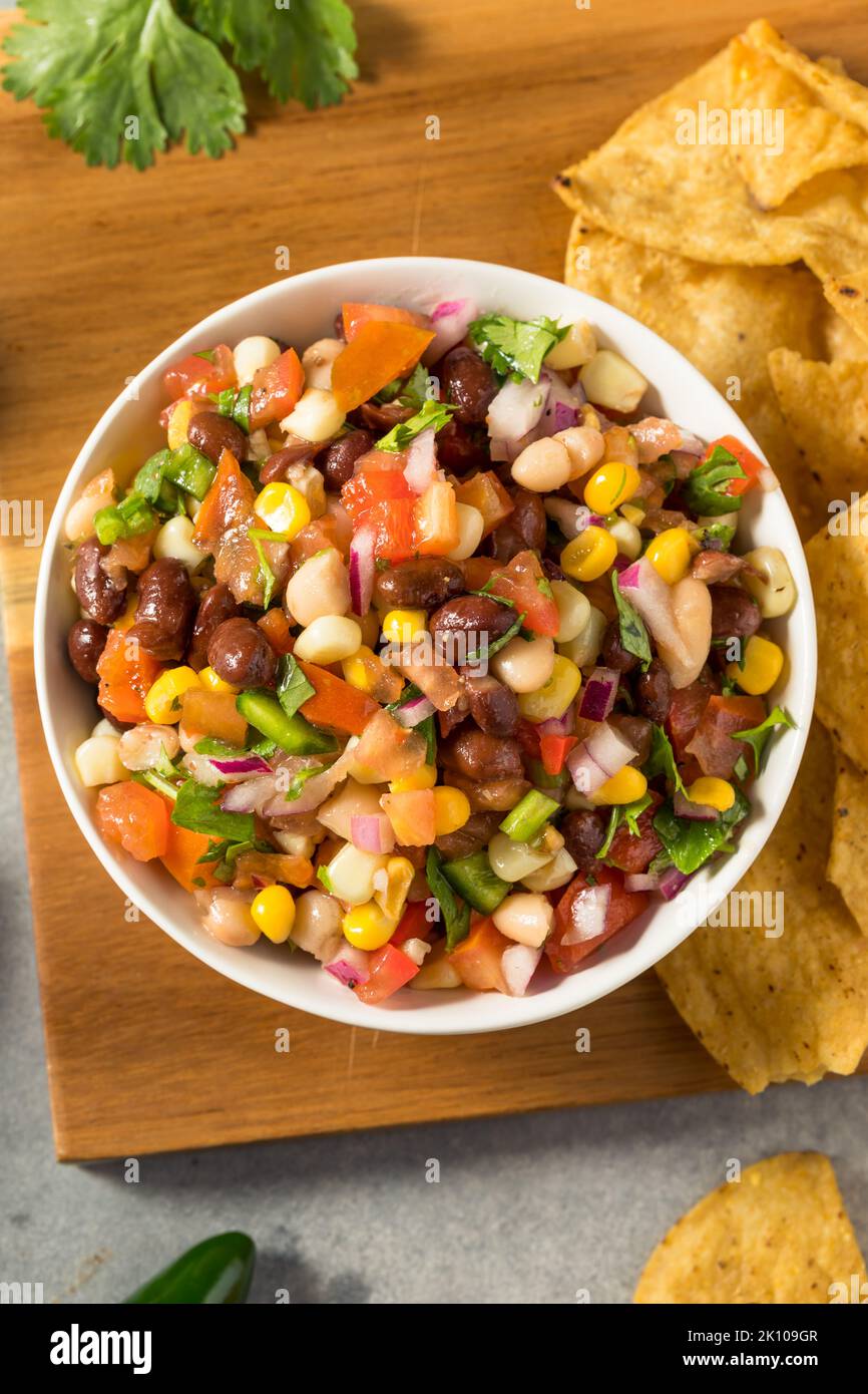 Homemade Organic Cowboy Caviar Dip with Corn Beans and Chips Stock Photo