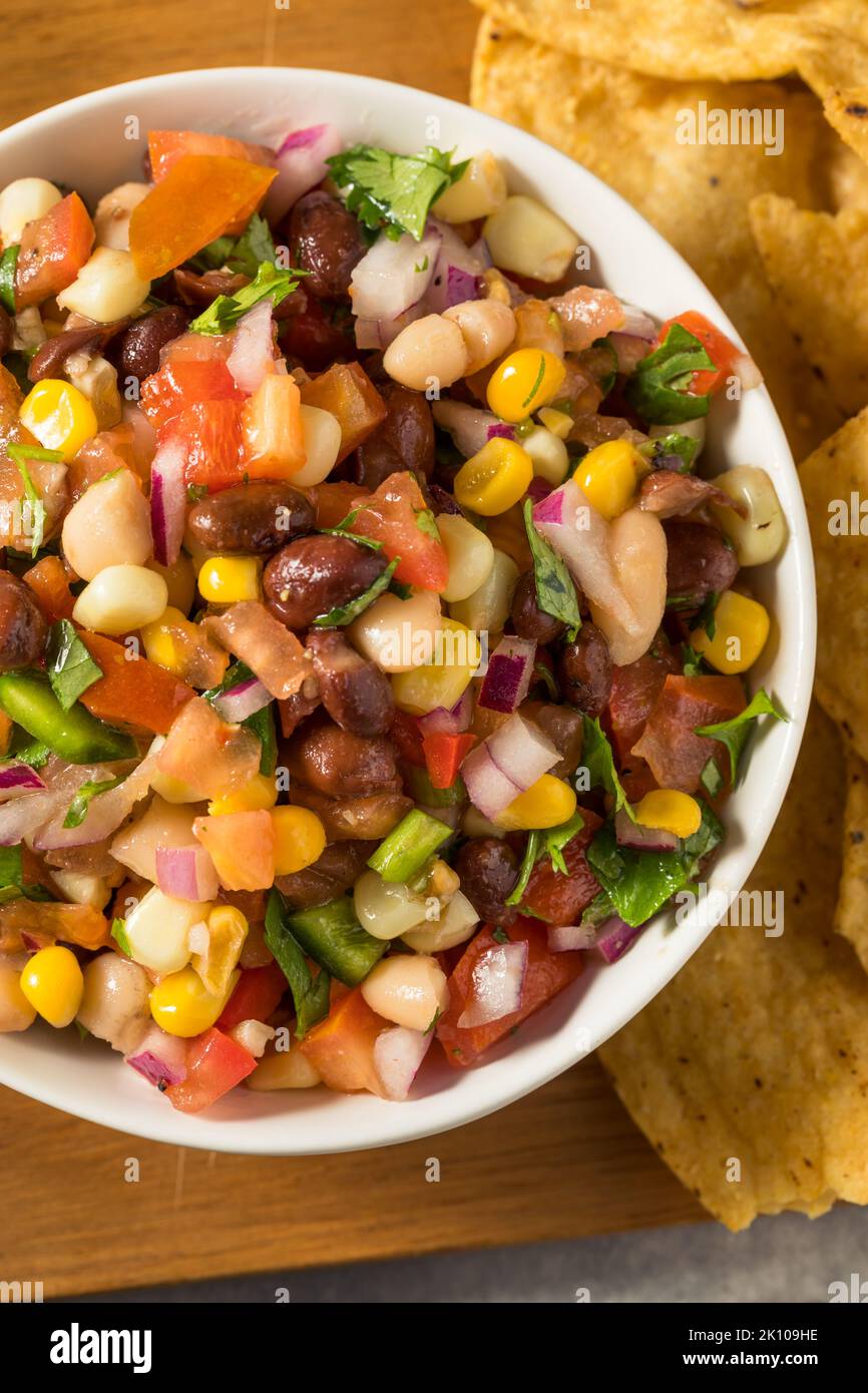 Homemade Organic Cowboy Caviar Dip with Corn Beans and Chips Stock Photo