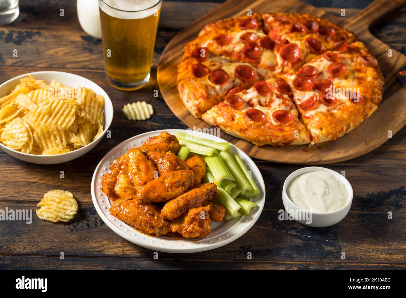Homemade Pepperoni Pizza Chicken Wings and Beer for a Football Party